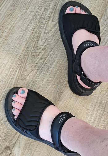 reviewer wearing comfy achromatic sandals