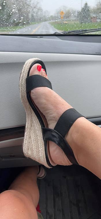 reviewer wearing a stylish achromatic level sandal with a woven wedge