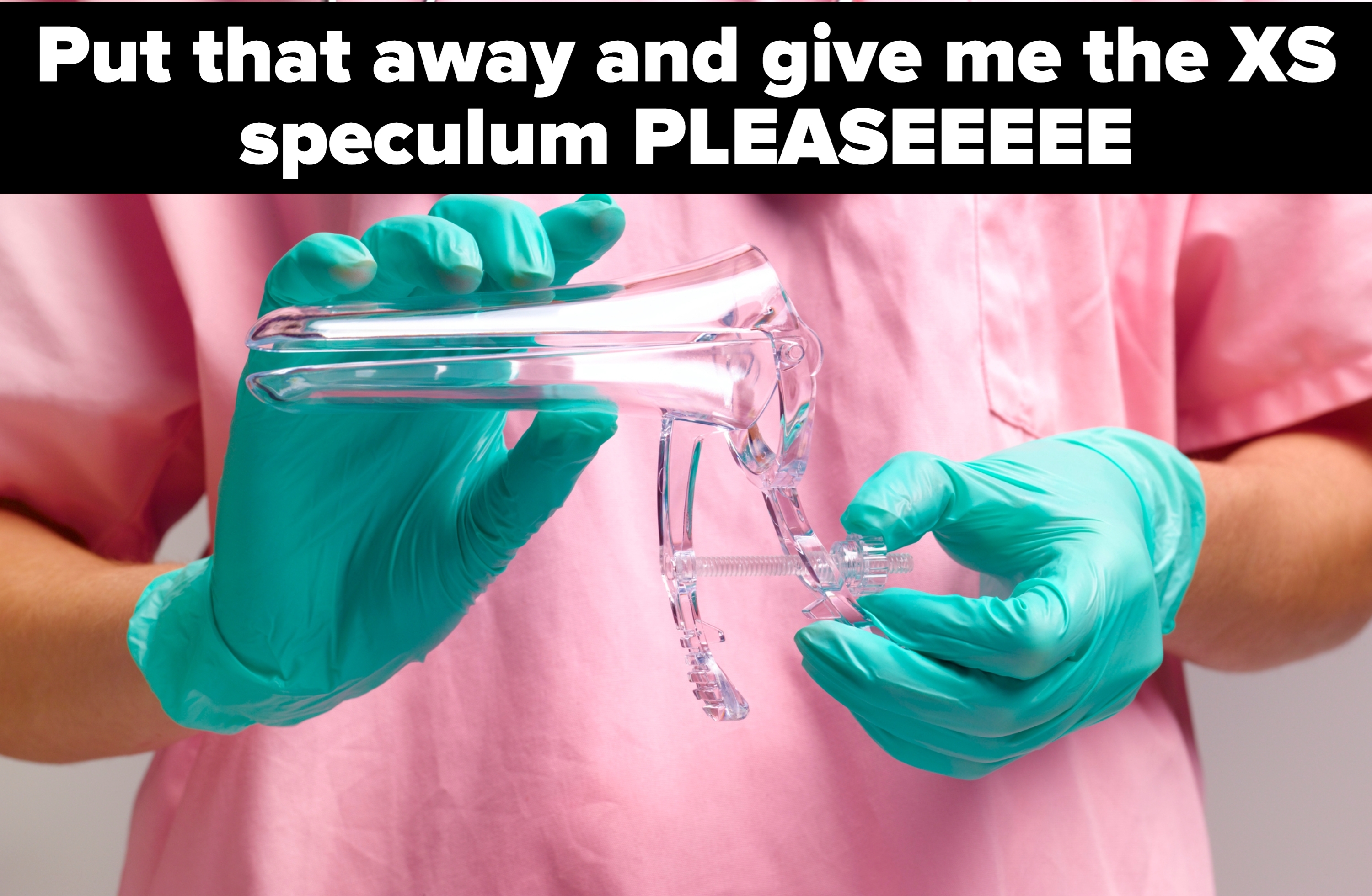 Person in scrubs and gloves holding a medical speculum with a stethoscope around their neck