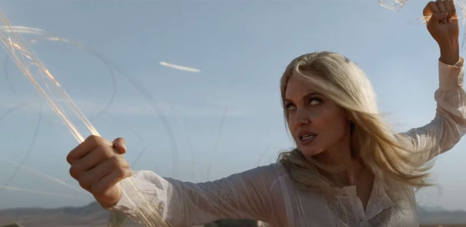 Close-up of Thena mid-battle against a blue sky in "Eternals"