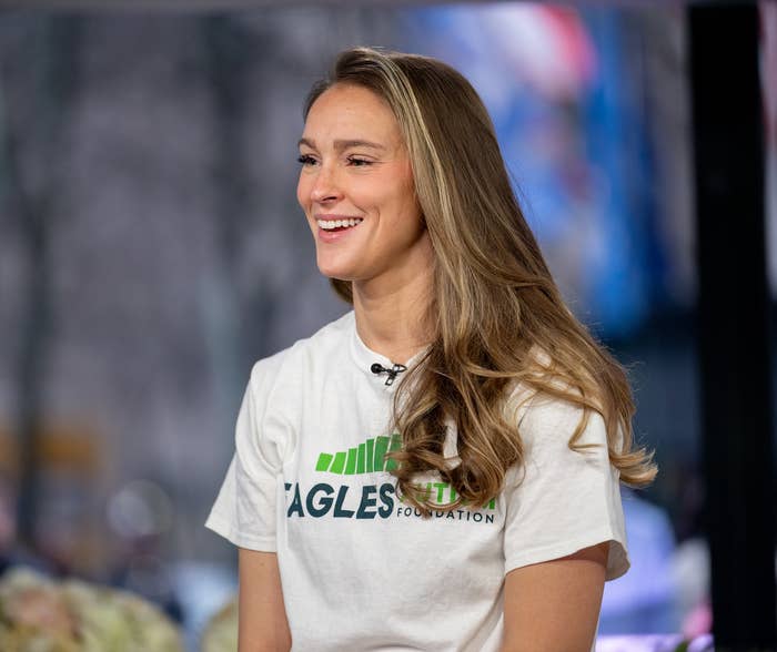 Kylie Kelce smiling, seated indoors