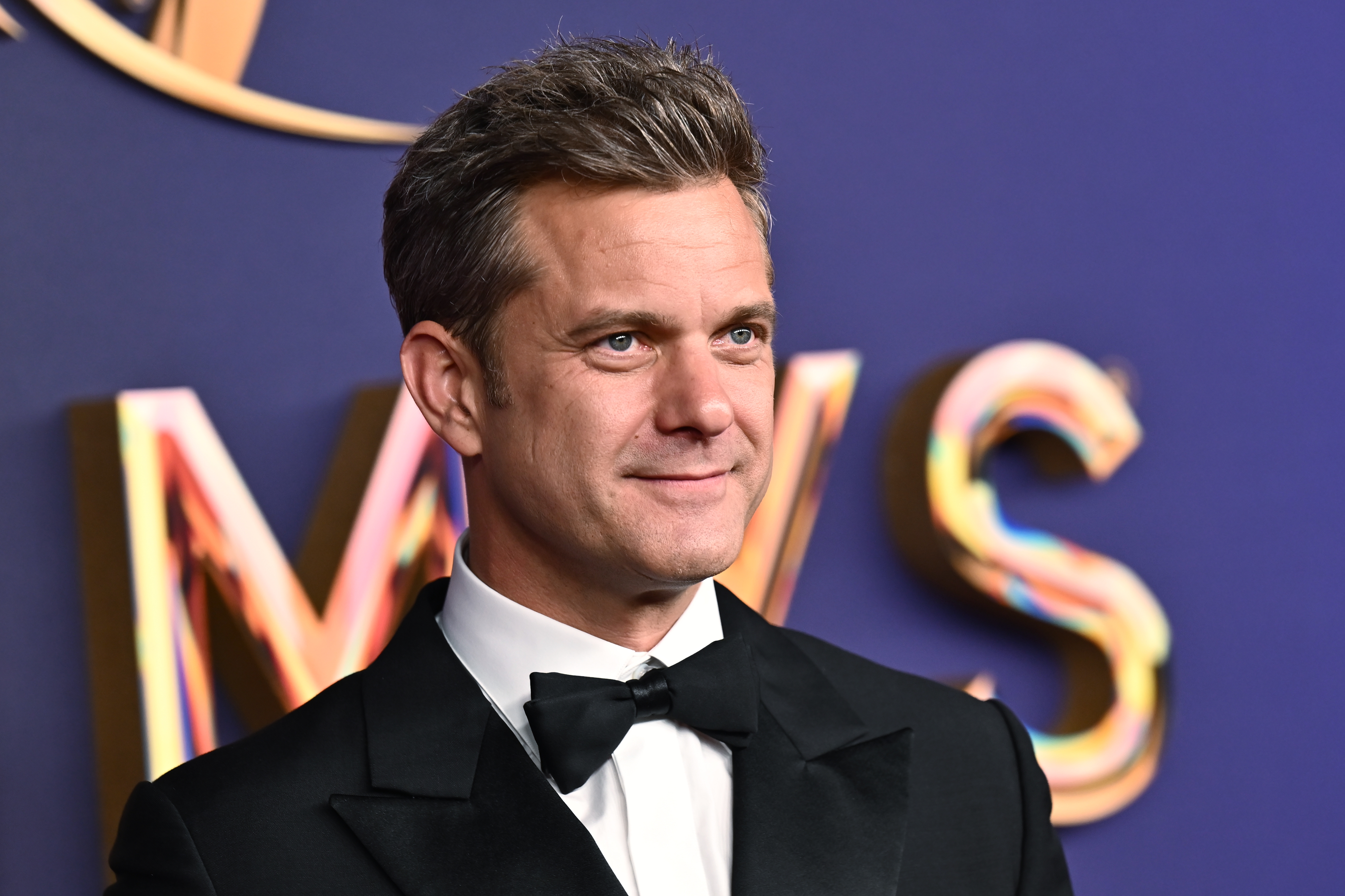 Joshua Jackson in a tuxedo and bow tie on a red carpet event