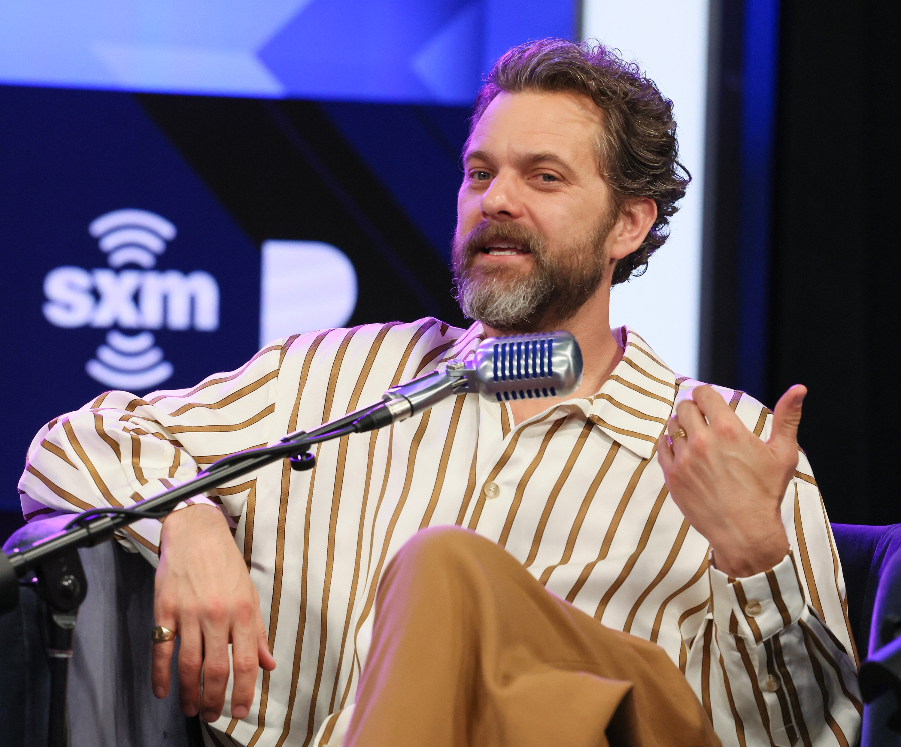 Joshua Jackson speaking into a microphone
