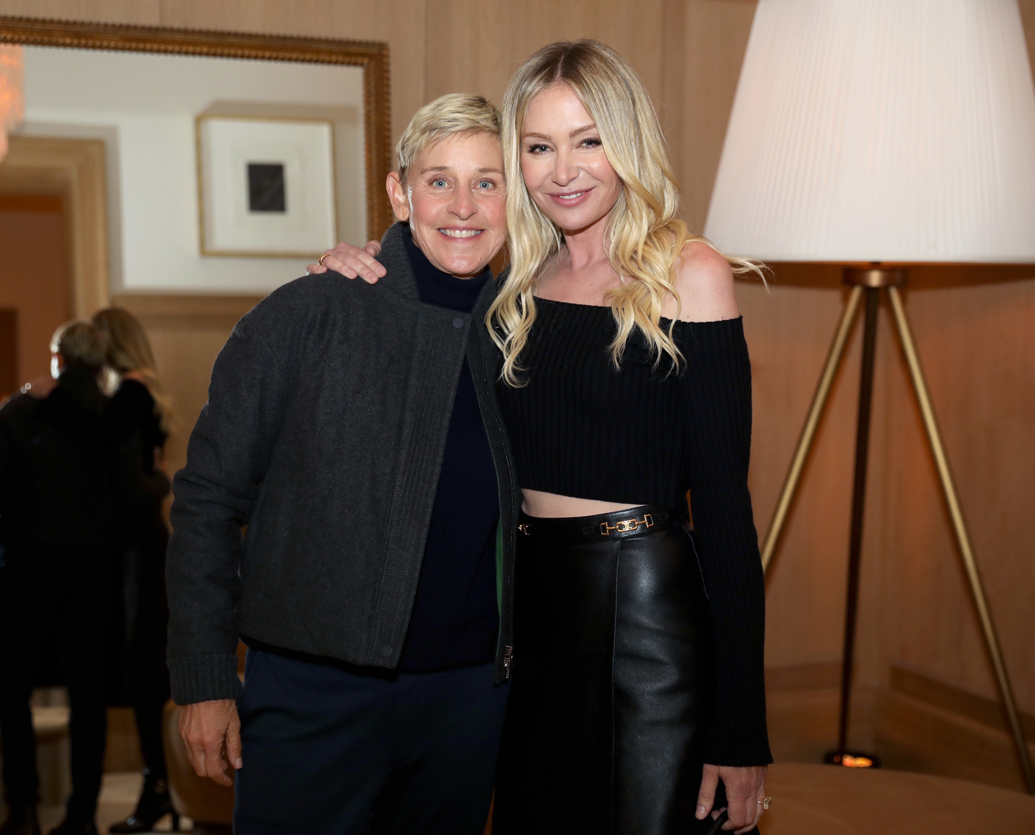 Ellen DeGeneres and Portia de Rossi smiling at an event