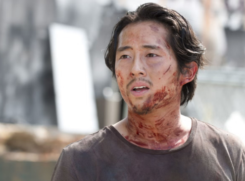 Glenn from "The Walking Dead" with blood all over his face, looking confused