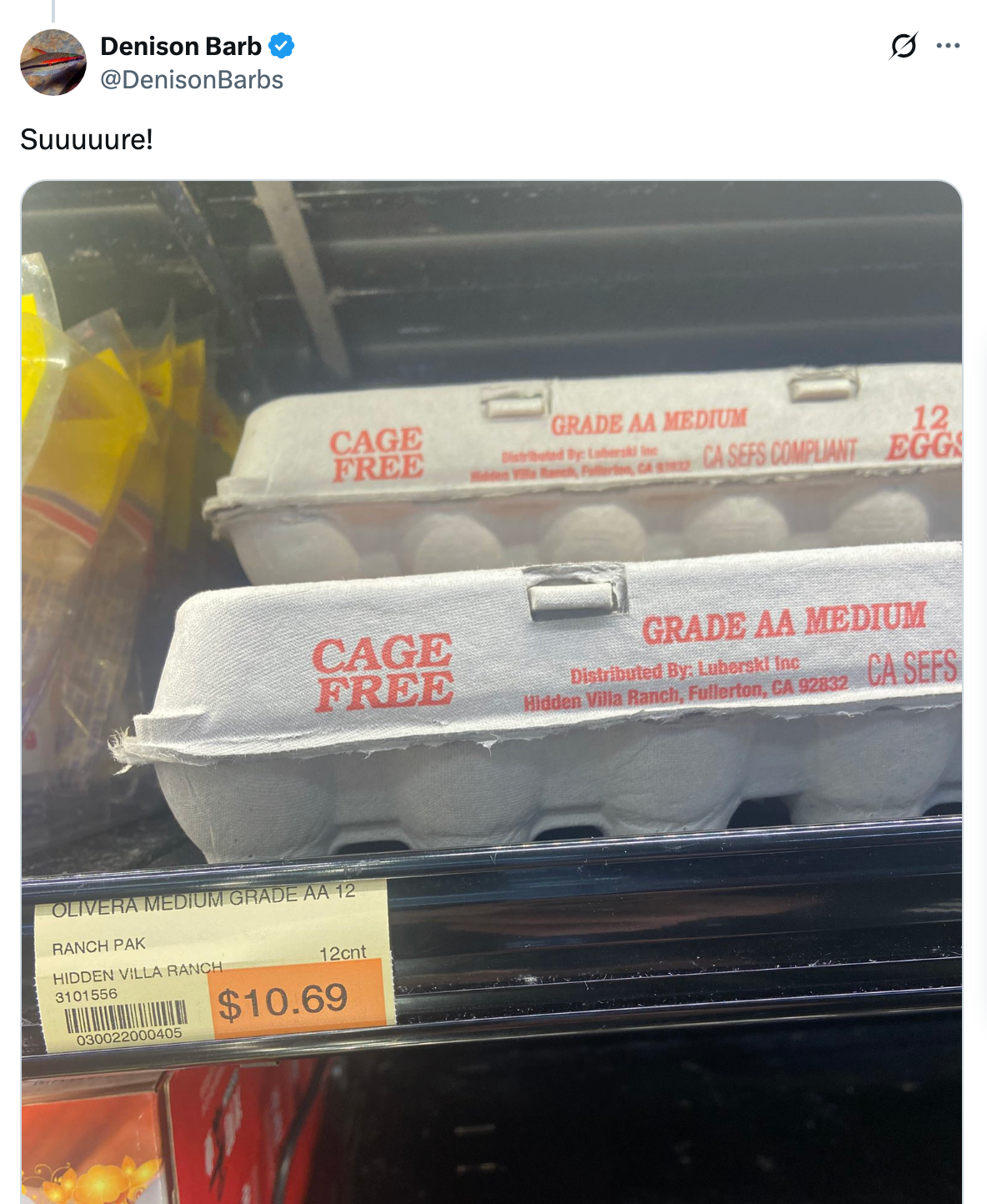 Egg cartons labeled "Cage Free" on a store shelf, priced at $10.69 per dozen
