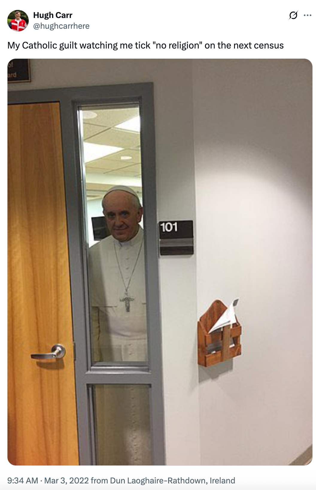 A person in papal attire looks through a narrow window on a door, with a humorous caption about Catholic guilt and the census