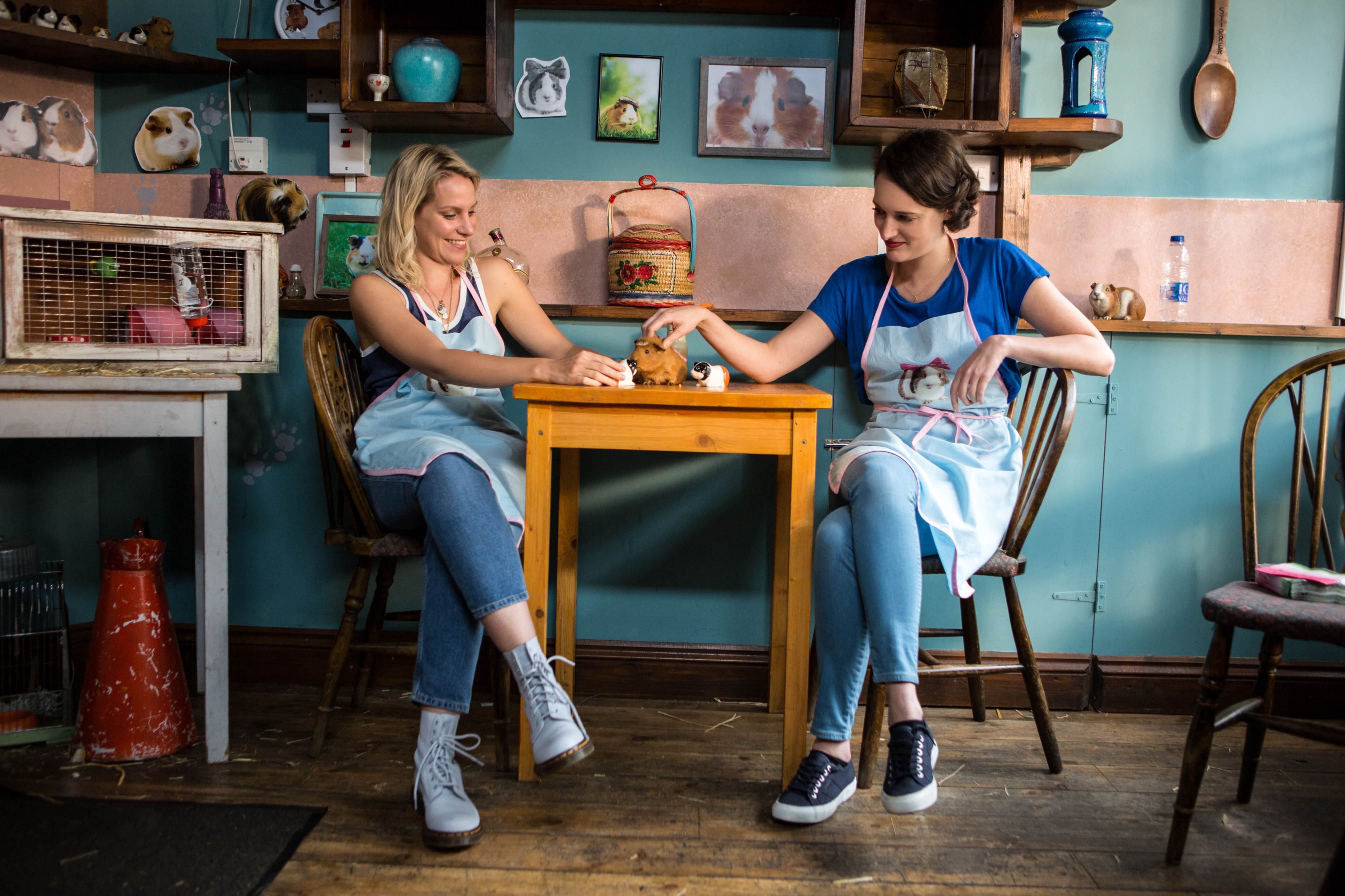 Boo and Fleabag from "Fleabag" sit together at a cafe table