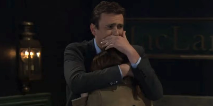 Marshall hugging Lily from "HIMYM" with a hand over his face, tearing up
