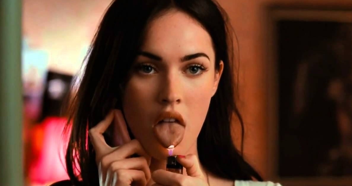 A person holds a lighter near their tongue while talking on the phone, creating a dramatic scene