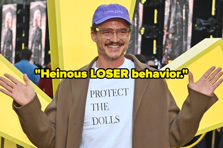 Celebrity smiles on yellow carpet, wearing a cap, glasses, tan coat, and shirt reading &ldquo;PROTECT THE DOLLS.&rdquo; Text overlay: &ldquo;Heinous LOSER behavior.&quot;