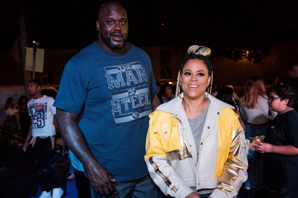 Two people attending an event; one in a graphic tee, the other in a trendy jacket