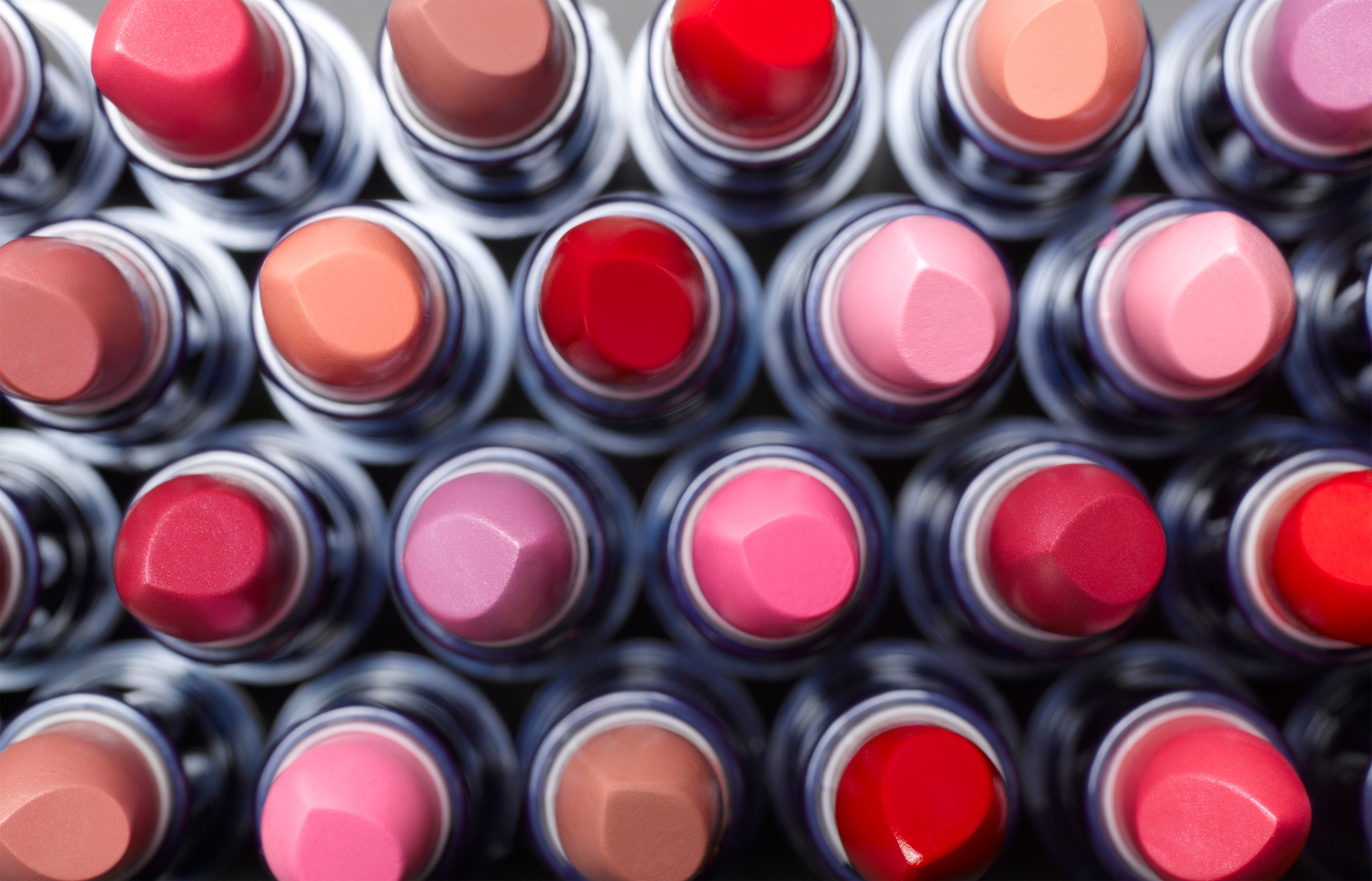 Rows of lipsticks from above, showing various shades