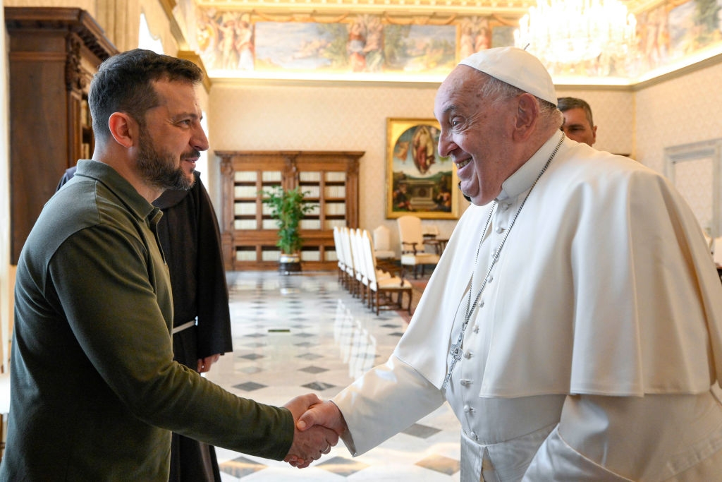 President Zelenskyy shakes hands with Pope Francis; both are smiling