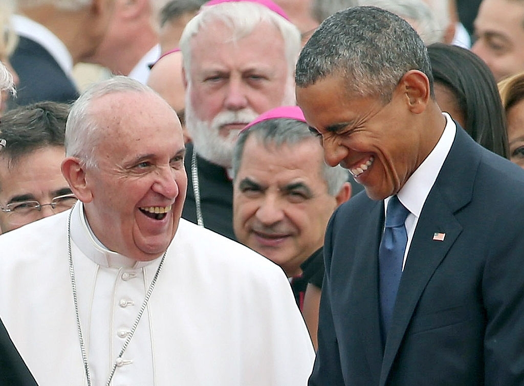Pope Francis and President Barack Obama laugh with a crowd behind them