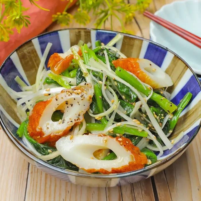 野菜とちくわのゴマ和えサラダが皿に盛られている。上にはゴマがちりばめられている。