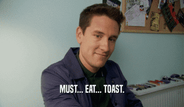 A person smiles at the camera with text overlay: "MUST… EAT… TOAST."