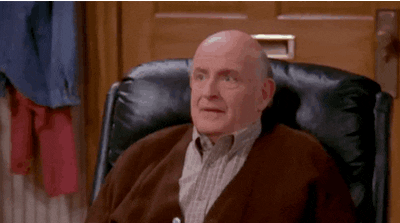 A man sitting in a recliner, looking surprised, in a scene from "Everybody Loves Raymond."