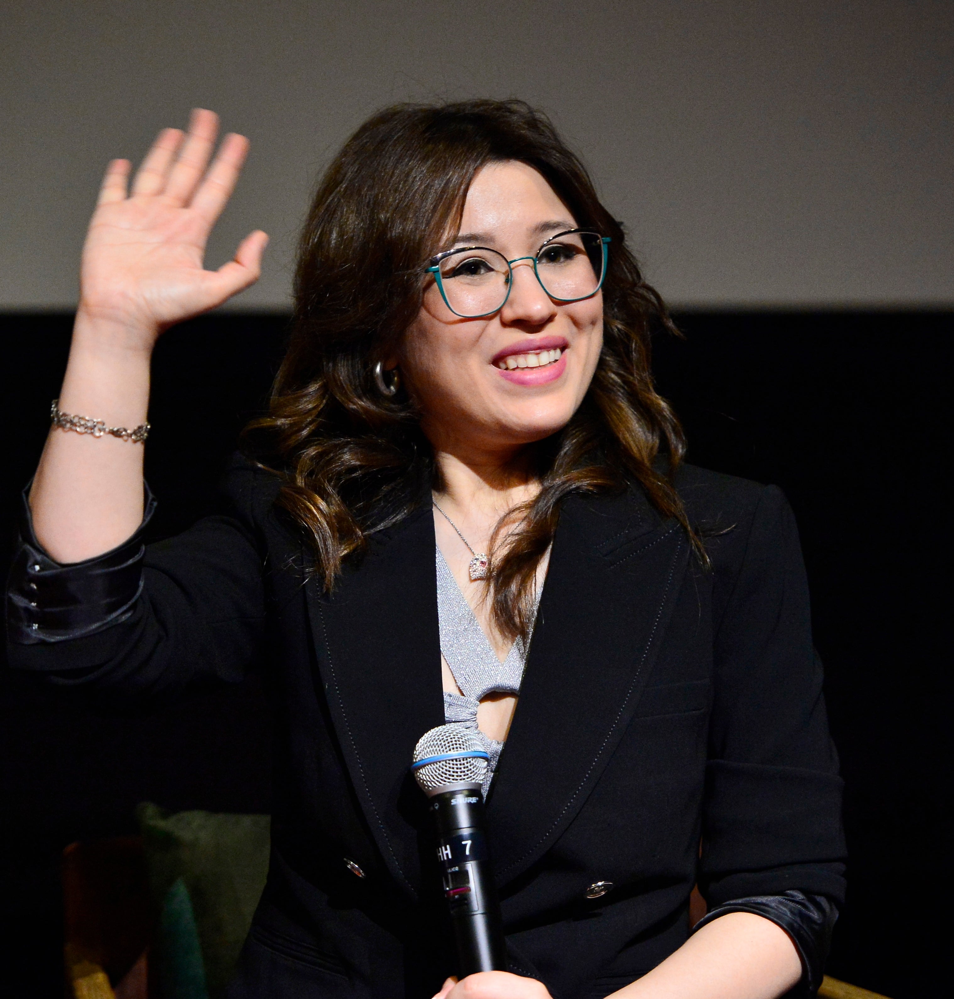 Dani Bowman smiling and speaking onstage at an event
