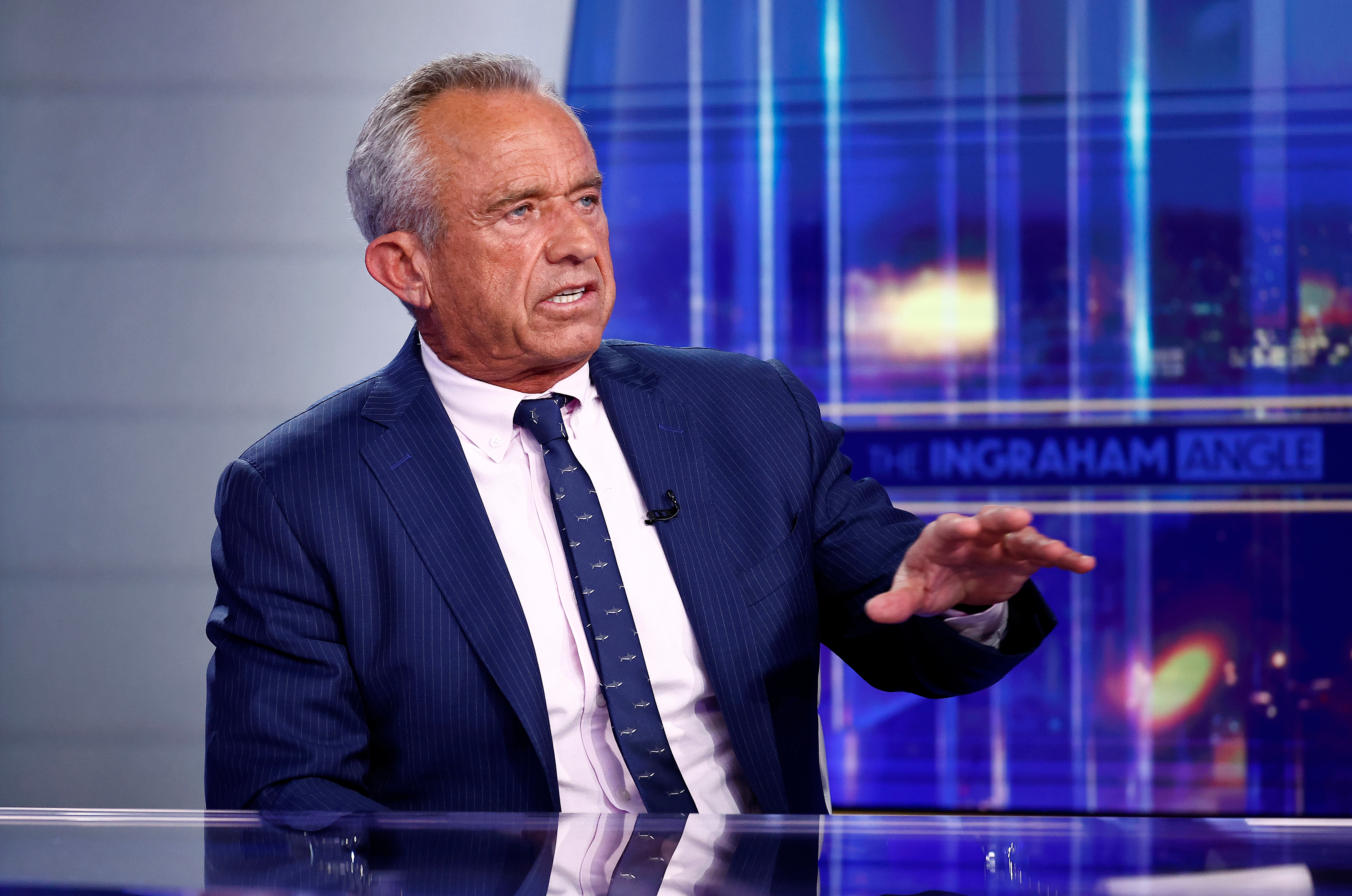 Robert F. Kennedy Jr. gesturing while speaking on a TV news show set