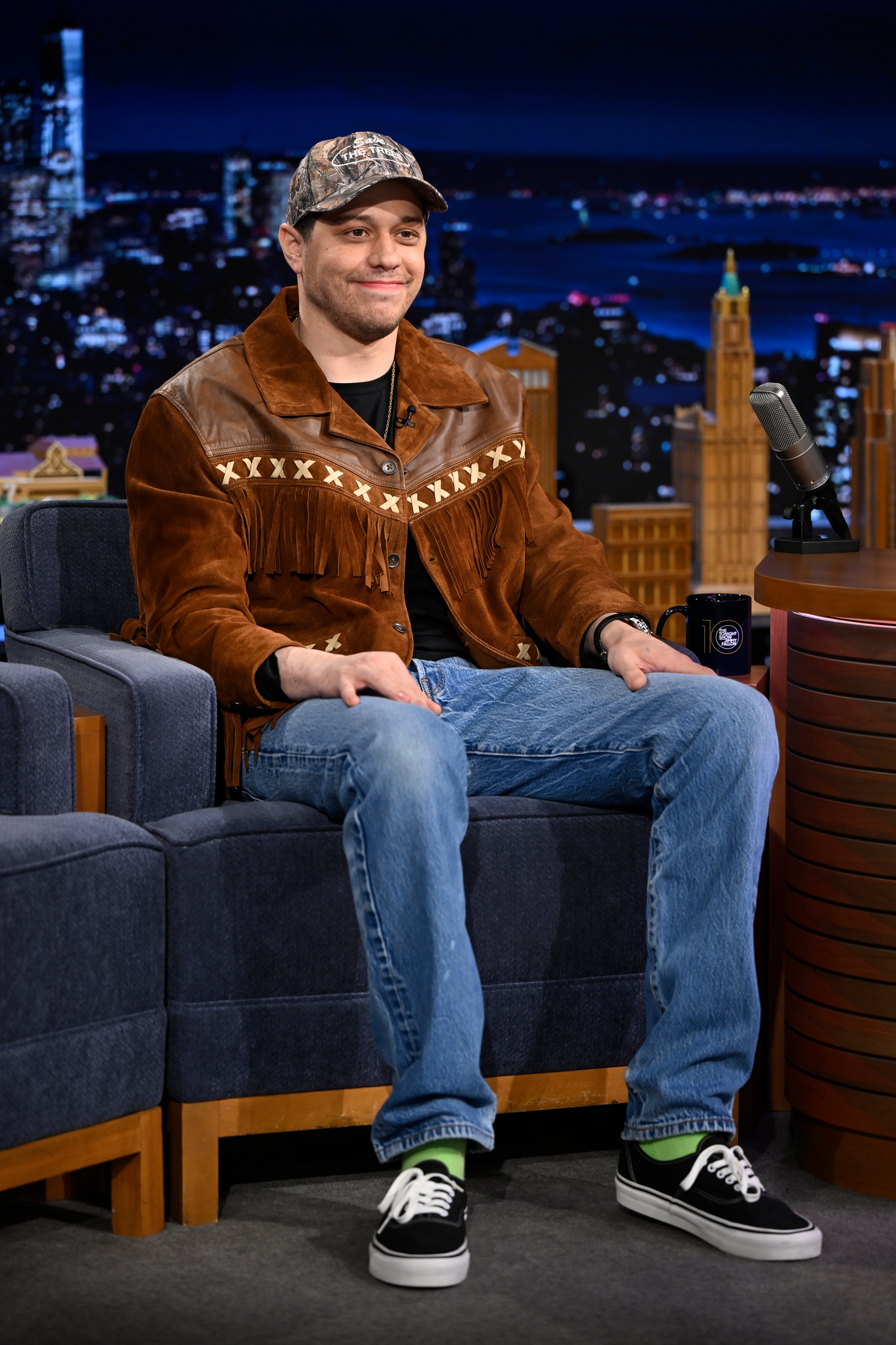Pete Davidson sitting on a talk show set