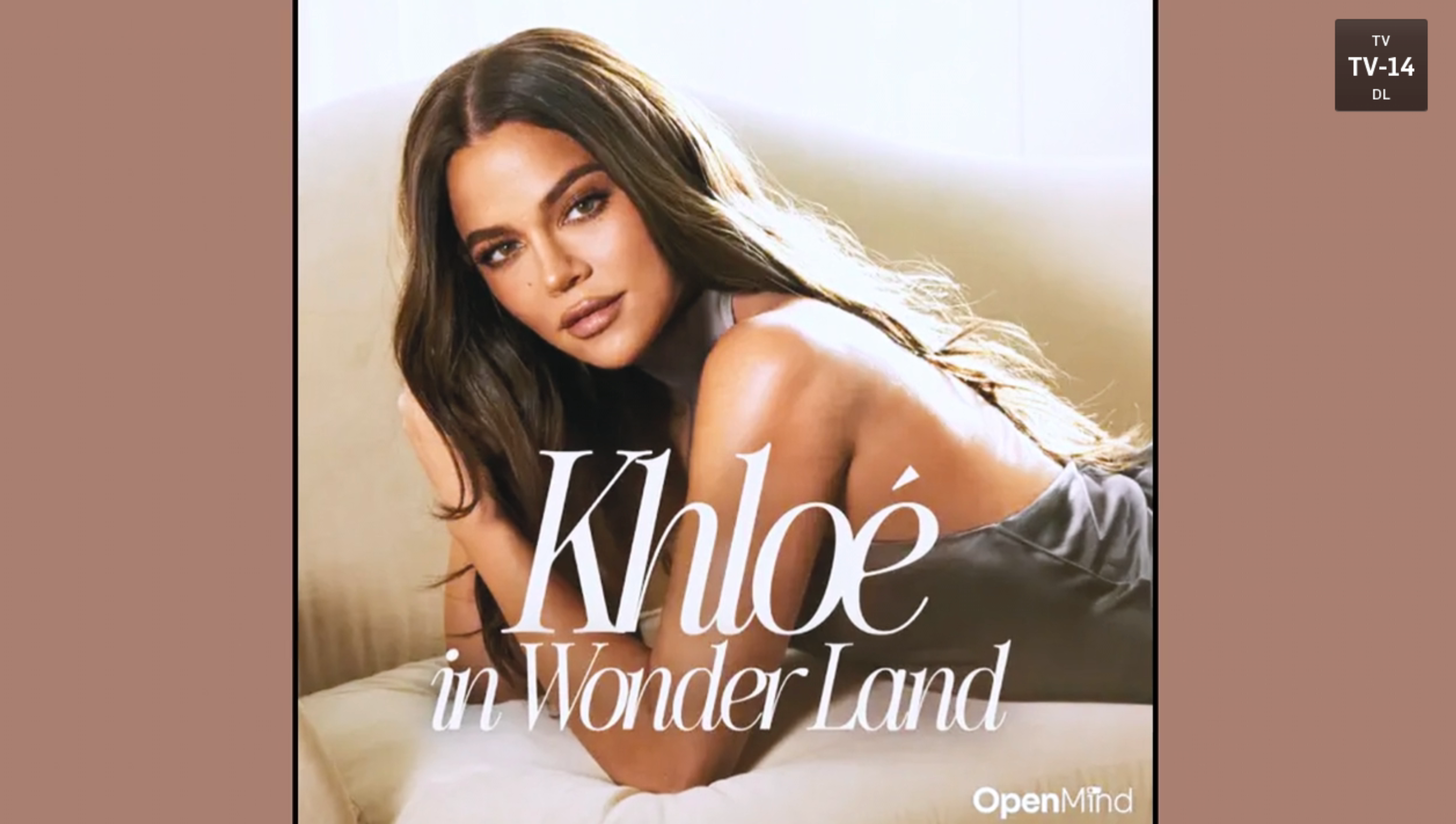 Person lounging on a sofa with the text &quot;Khloé in Wonderland&quot; displayed prominently