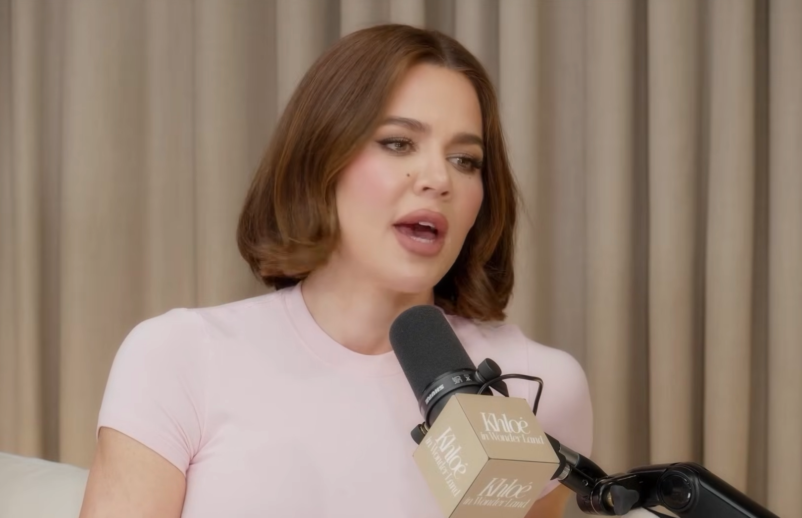 Khloé Kardashian speaking on a podcast