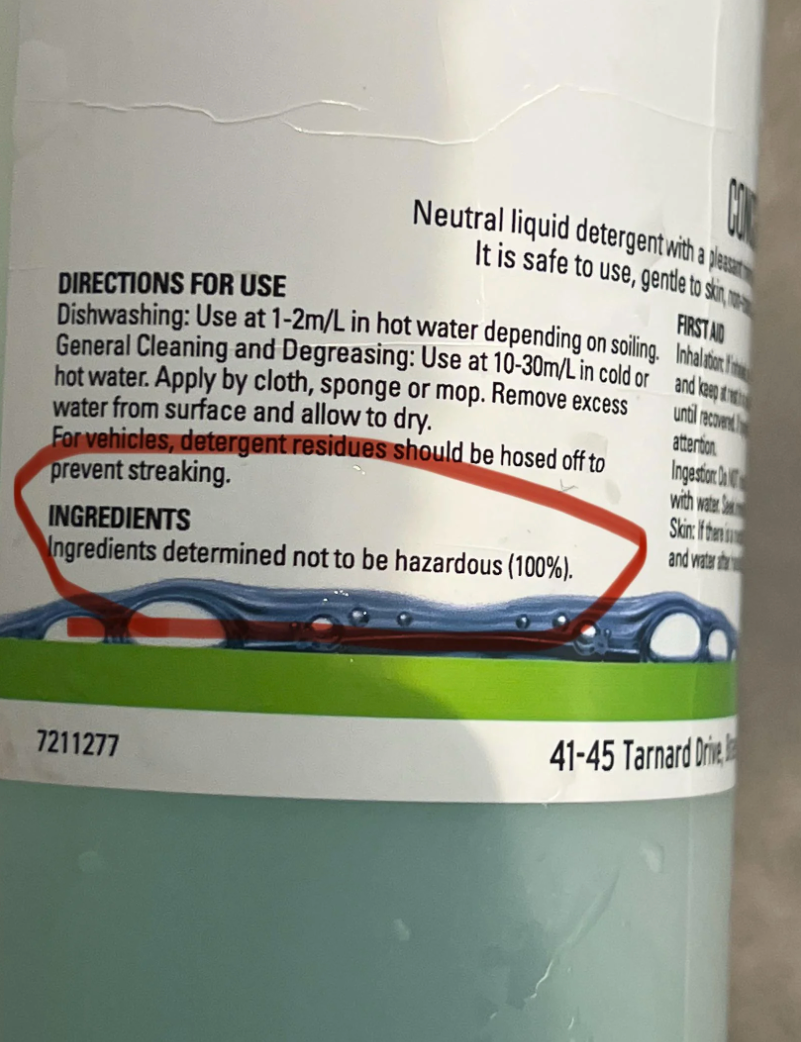 Labeled liquid detergent bottle with text highlighting use instructions and ingredients, noting all ingredients are 100% non-hazardous