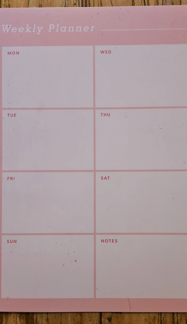 Blank weekly planner with sections for each day and notes