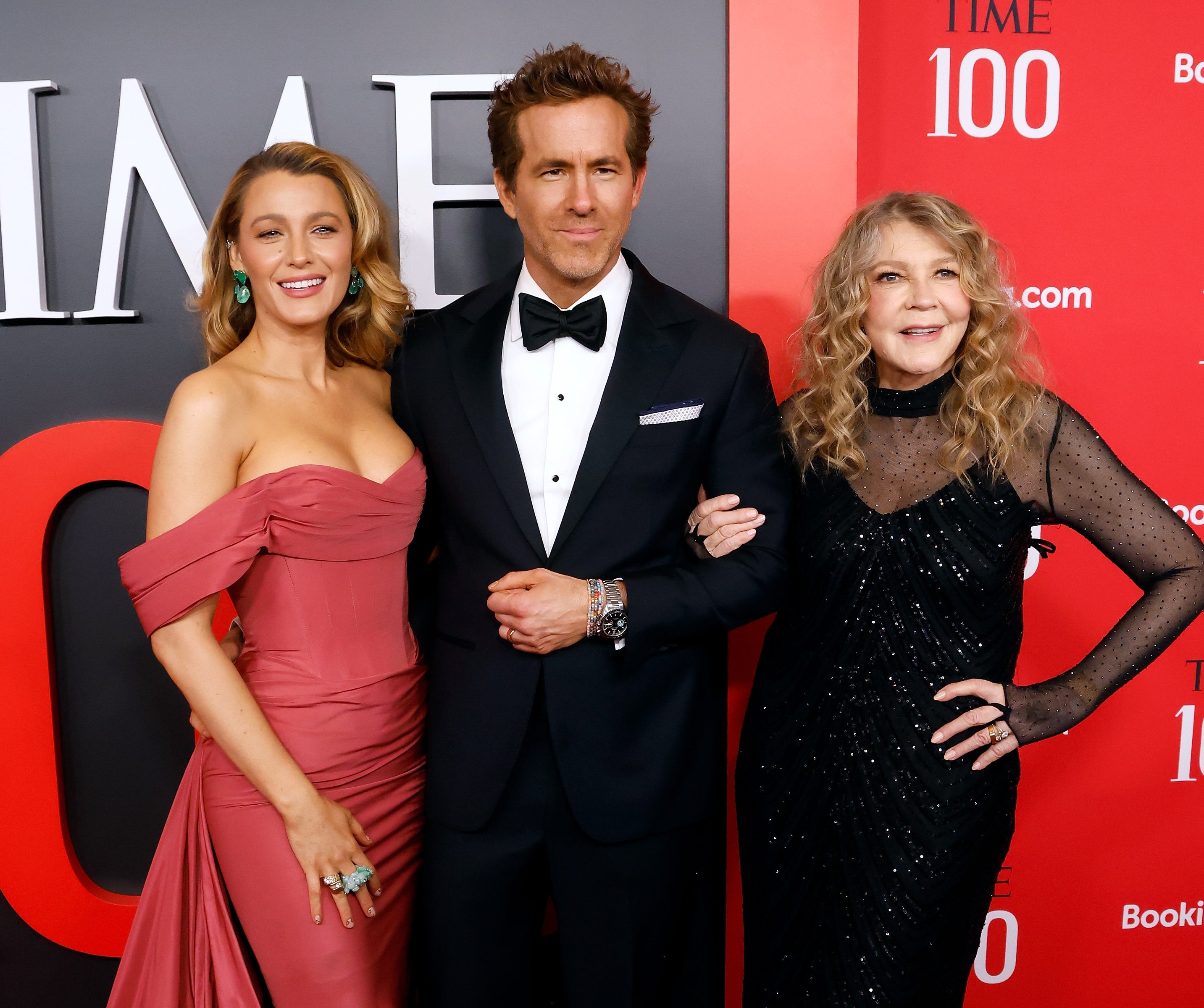 Blake Lively, Ryan Reynolds, and Blake's mom posing on a red carpet