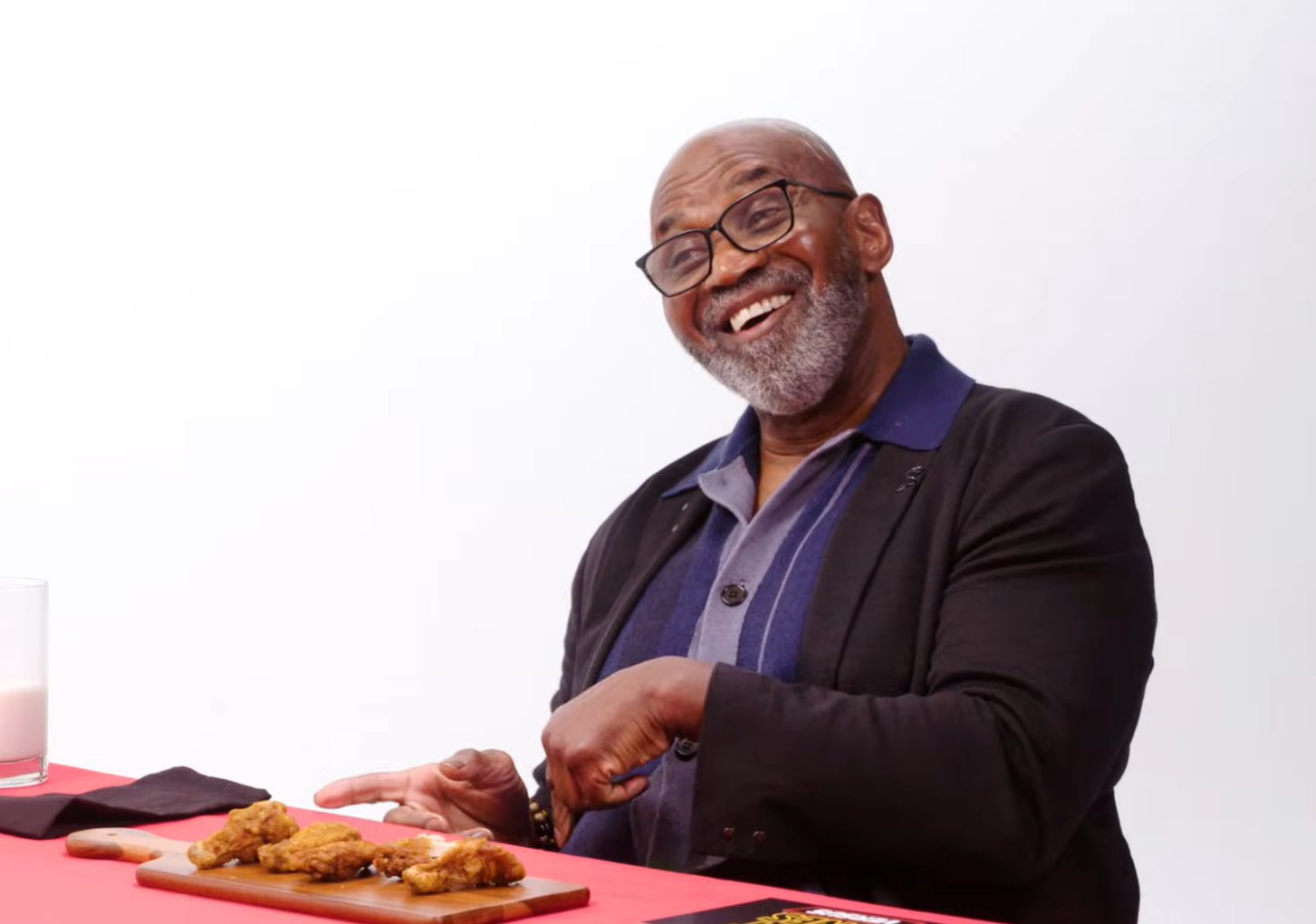 Julius Tennon smiling during a "Hot Ones" appearance