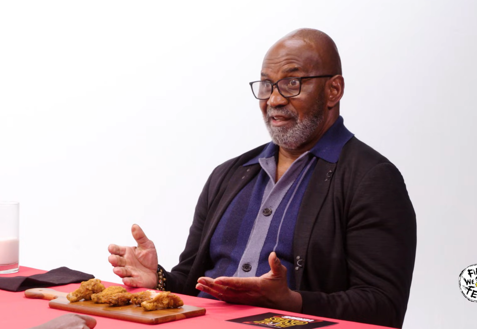 Julius Tennon talking animatedly on on "Hot Ones"