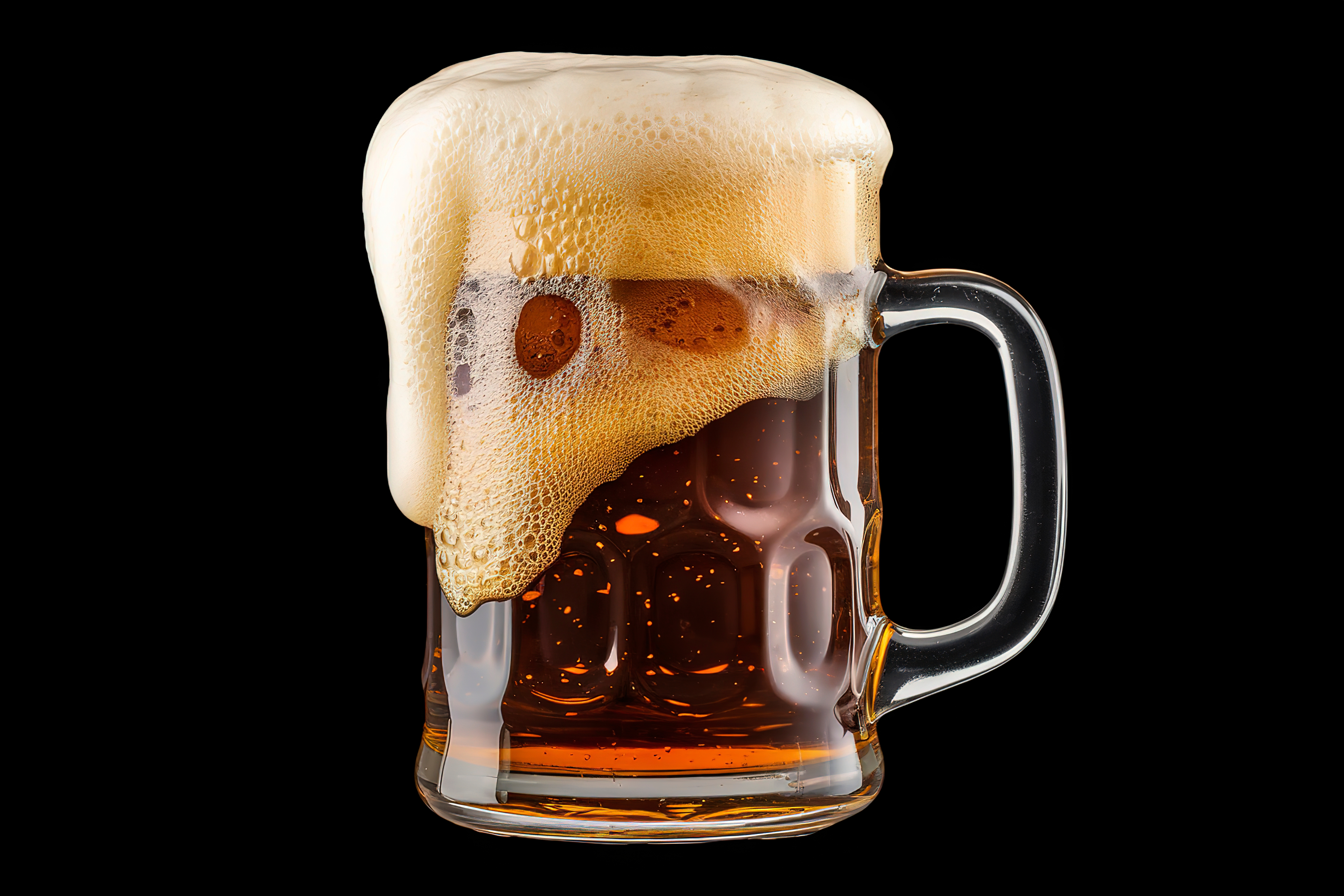A frothy mug of beer with foam spilling over the top against a dark background