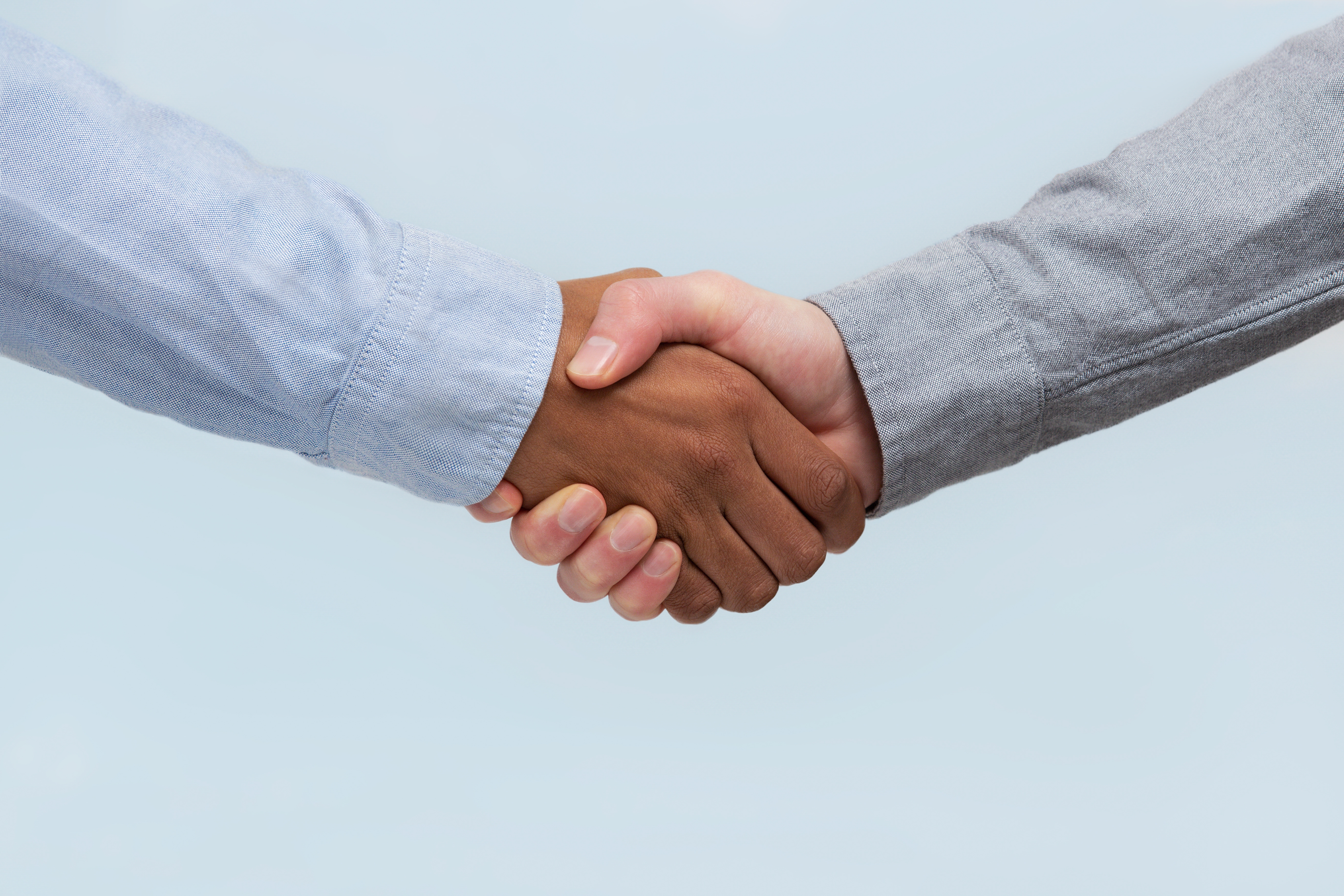 Two people shaking hands, symbolizing agreement or partnership