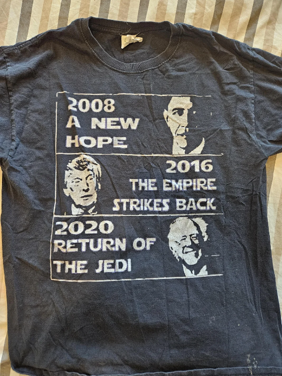T-shirt with text: "2008 A New Hope" (with a photo of Barack Obama), "2016 The Empire Strikes Back" (with a photo of Donald Trump), and "2020 Return of the Jedi" with a photo of Bernie Sanders