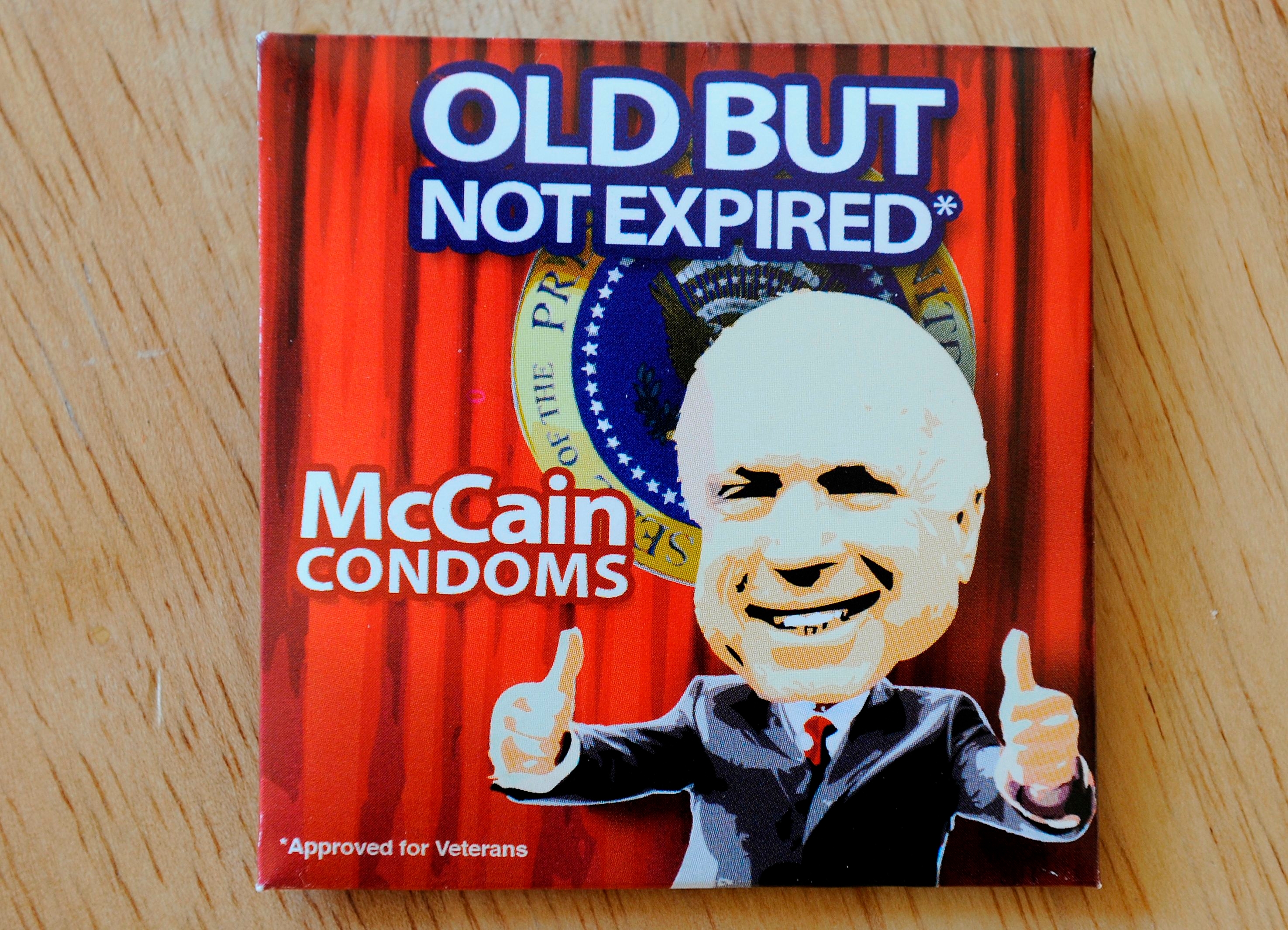 Box of novelty condoms labeled "Old But Not Expired," featuring a cartoon of a well-known political figure with thumbs up
