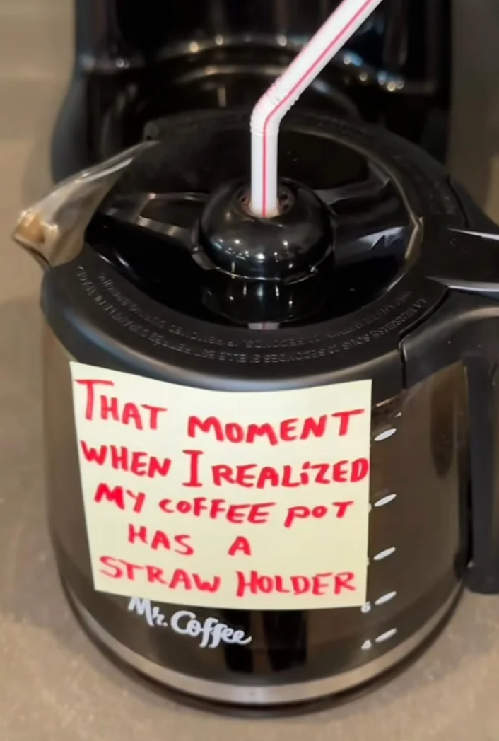 Coffee pot with a sticky note saying, "That moment when I realized my coffee pot has a straw holder," referring to the hole in the lid