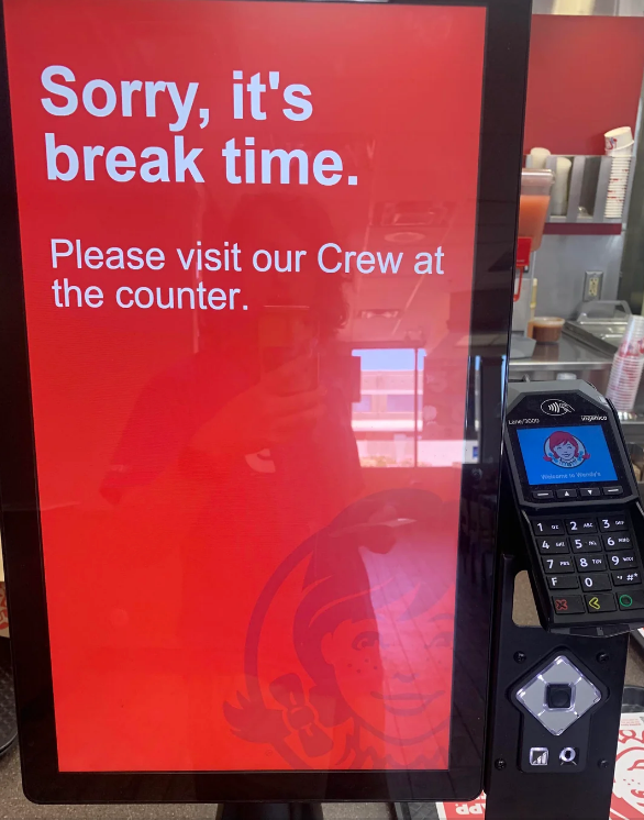 Fast-food ordering kiosk with text: "Sorry, it's break time. Please visit our Crew at the counter"