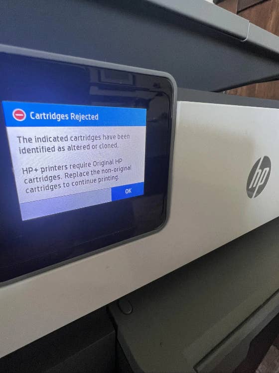 Printer screen displays "Cartridges Rejected. The indicated cartridges have been identified as altered or cloned. Use Original HP cartridges"