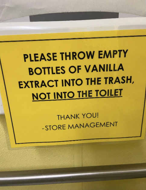 Sign requests throwing empty vanilla extract bottles in trash, not toilet. "Thank you! - Store Management."