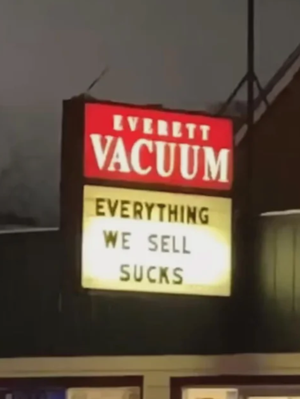 Store sign reads: "Everett Vacuum. Everything we sell sucks."