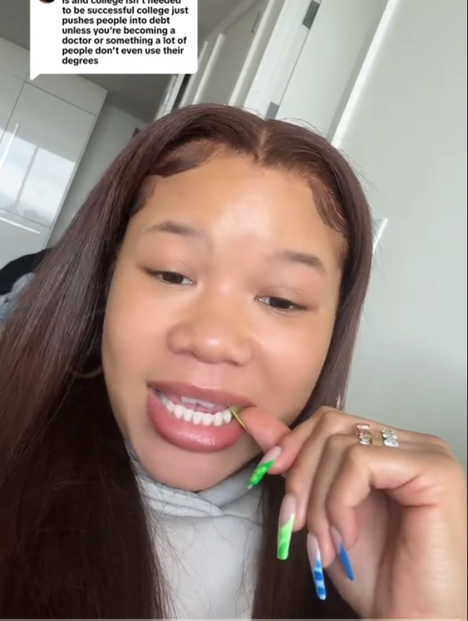 Person with colorful nails holds a toothpick, showcasing a text box discussing college degrees and success