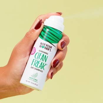Hand holding a tin of