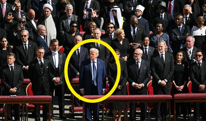 A diverse group of world leaders and diplomats stand together at a formal gathering, dressed in formal attire, some in traditional garments