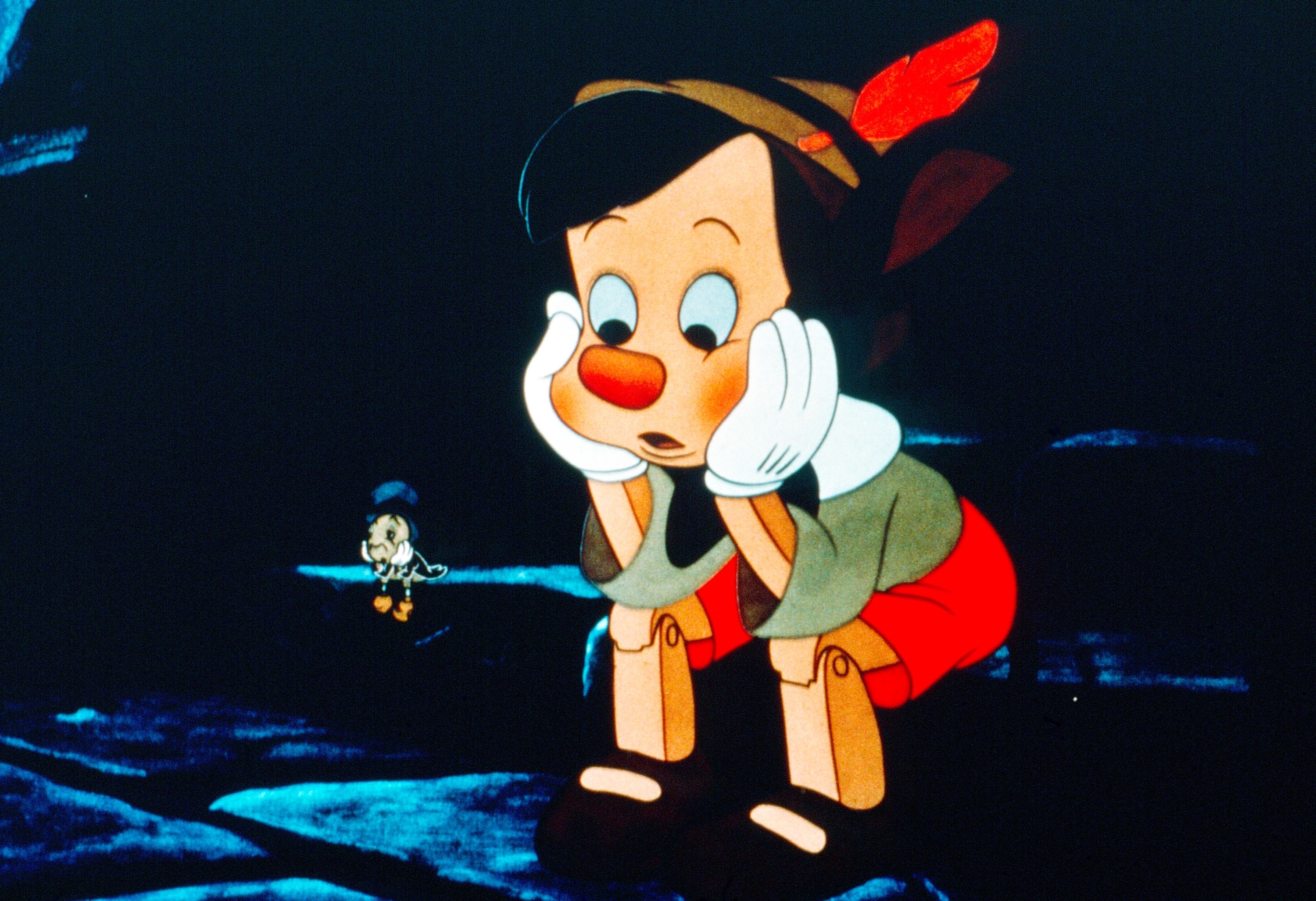 Animated character Pinocchio looking thoughtful, sitting with head in hands, while a small cricket talks to him