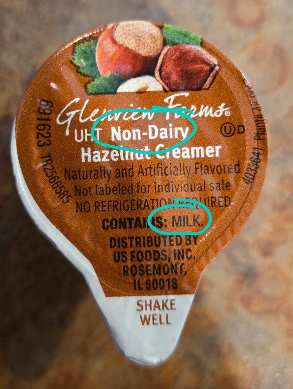 Coffee creamer label states "Non-Dairy Hazelnut Creamer" but also lists milk as an ingredient, highlighting a contradictory packaging error