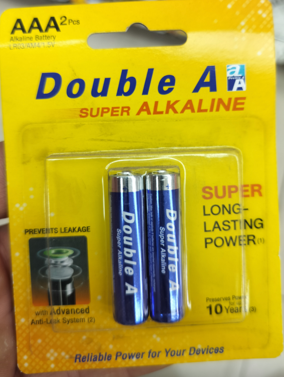 Package of two AA batteries labeled "Double A Super Alkaline," promoting long-lasting power and leak prevention technology