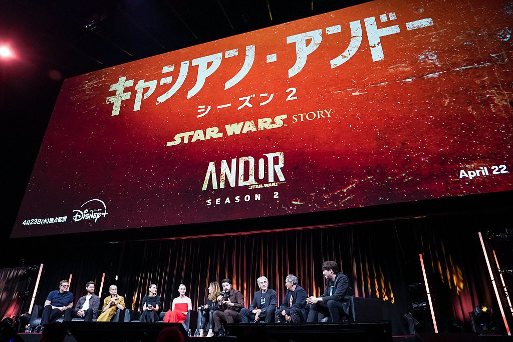 Cast panel for "Andor" Season 2 with actors seated on stage under a large screen displaying the show's title and release date