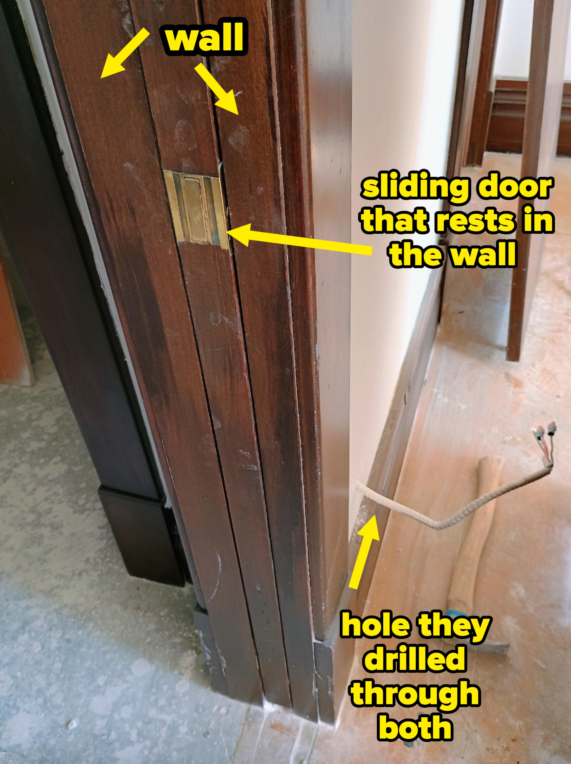 A door slightly ajar shows a wire protruding from the wall and a hammer on the floor, hinting at ongoing home renovation or repair work