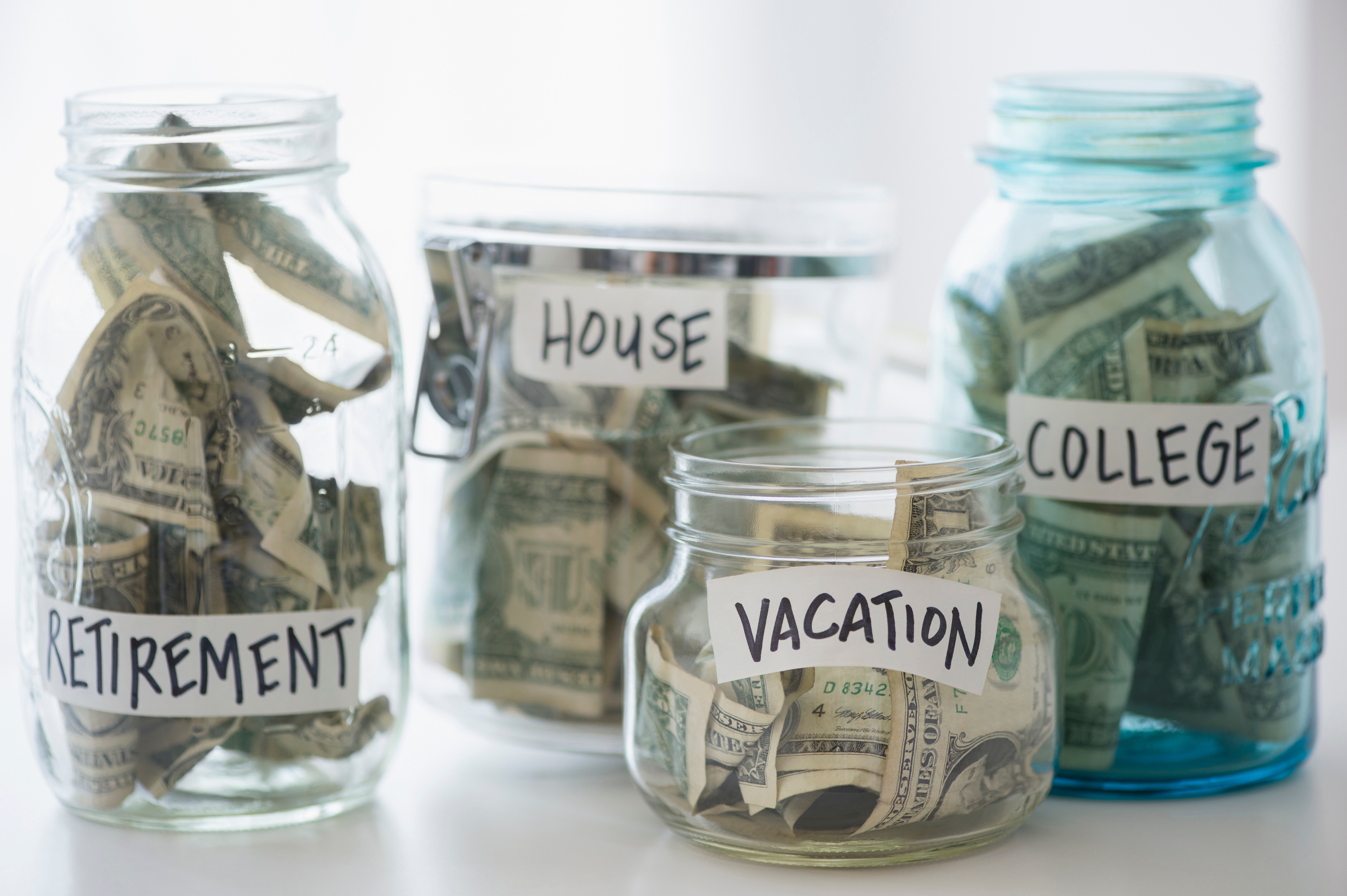 Money jars indicating savings for retirement, house, vacation, and college.
